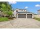 Beautiful two-story home features a three car garage, manicured lawn, and well-maintained landscaping at 21108 Bircholm Ct, Land O Lakes, FL 34637