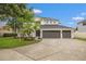Beautiful two-story home features a three car garage, manicured lawn, and well-maintained landscaping at 21108 Bircholm Ct, Land O Lakes, FL 34637