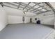 Garage with neutral-colored epoxy flooring and white walls, providing a clean and functional space at 21108 Bircholm Ct, Land O Lakes, FL 34637