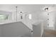 Bright hallway with white walls, neutral carpet, and multiple doorways leading to rooms at 21108 Bircholm Ct, Land O Lakes, FL 34637