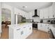Modern kitchen features white cabinets, stainless steel appliances, and a central island, complemented by sleek countertops at 21108 Bircholm Ct, Land O Lakes, FL 34637