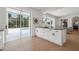 Well-lit kitchen features a large island with seating and seamless transition to an outdoor swimming pool at 21108 Bircholm Ct, Land O Lakes, FL 34637