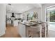 Bright kitchen features a large island with seating and sleek white cabinets, with a seamless transition to outdoor views at 21108 Bircholm Ct, Land O Lakes, FL 34637