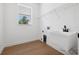 Bright laundry room with a utility sink, wire shelving, and wood-look floors at 21108 Bircholm Ct, Land O Lakes, FL 34637