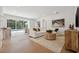 Open living area with wood floors, comfortable seating, and a view of the swimming pool at 21108 Bircholm Ct, Land O Lakes, FL 34637