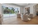 Open living area featuring chairs, view of the pool, and hardwood floors at 21108 Bircholm Ct, Land O Lakes, FL 34637
