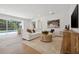 Spacious living room featuring hardwood floors, comfortable seating, and view of backyard pool at 21108 Bircholm Ct, Land O Lakes, FL 34637