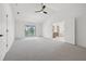 Large main bedroom with balcony access, neutral carpet, and an ensuite bathroom at 21108 Bircholm Ct, Land O Lakes, FL 34637