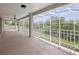 Large screened-in patio with ceiling fan showcasing the expansive backyard at 21108 Bircholm Ct, Land O Lakes, FL 34637