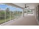 Covered patio overlooking the backyard, complete with a ceiling fan and screen enclosure at 21108 Bircholm Ct, Land O Lakes, FL 34637