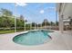 Screened-in pool and hot tub featuring a unique shape and tile accents, perfect for relaxation at 21108 Bircholm Ct, Land O Lakes, FL 34637