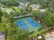 Aerial view of community tennis courts surrounded by lush landscaping at 21108 Bircholm Ct, Land O Lakes, FL 34637