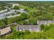 Aerial view of residential homes, mature tree coverage, and surrounding landscape at 2175 Fox Chase Blvd, Palm Harbor, FL 34683