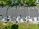 Aerial view of back patios with view of trees and roofs at 2175 Fox Chase Blvd, Palm Harbor, FL 34683
