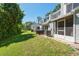 Wide view of the backyard and exterior of townhomes on a sunny day at 2175 Fox Chase Blvd, Palm Harbor, FL 34683