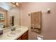 Cozy bathroom with a vanity, mirror, and towel rack, offering a functional and tidy space at 2175 Fox Chase Blvd, Palm Harbor, FL 34683