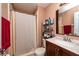 Practical bathroom with a bathtub and shower, vanity, mirror, and organized storage solutions at 2175 Fox Chase Blvd, Palm Harbor, FL 34683