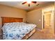 Spacious bedroom featuring carpet floors, a ceiling fan, and a view to the closet area and bathroom at 2175 Fox Chase Blvd, Palm Harbor, FL 34683