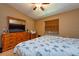 Comfortable bedroom with ample natural light, dresser, and TV, creating a relaxing and functional space at 2175 Fox Chase Blvd, Palm Harbor, FL 34683