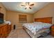 Inviting bedroom with carpet floors, a window with blinds, and a ceiling fan for added comfort at 2175 Fox Chase Blvd, Palm Harbor, FL 34683