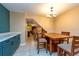 Bright dining area with tile floors, modern lighting fixture, and access to the hallway and living room at 2175 Fox Chase Blvd, Palm Harbor, FL 34683