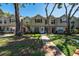 Inviting townhomes with sidewalks, mature trees, and manicured lawns at 2175 Fox Chase Blvd, Palm Harbor, FL 34683