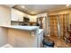 Well-lit kitchen featuring white cabinets and stainless steel appliances at 2175 Fox Chase Blvd, Palm Harbor, FL 34683