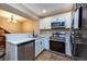 Updated kitchen showcasing white cabinets and stainless steel appliances at 2175 Fox Chase Blvd, Palm Harbor, FL 34683