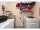 Laundry room with washer, dryer, water heater, and shelving for storage at 2175 Fox Chase Blvd, Palm Harbor, FL 34683