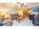 Cozy living room featuring tile floors, a ceiling fan, and staircase access at 2175 Fox Chase Blvd, Palm Harbor, FL 34683