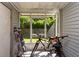 Enclosed porch with screen windows offers natural light and views to the exterior at 2175 Fox Chase Blvd, Palm Harbor, FL 34683
