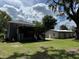 Expansive backyard with a screened-in porch and a detached garage at 222 Spring Lake Hwy, Brooksville, FL 34602