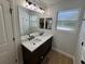 Bathroom features double sinks and large mirror at 222 Spring Lake Hwy, Brooksville, FL 34602
