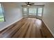 Bright bedroom with bay window, ceiling fan, and hardwood floors at 222 Spring Lake Hwy, Brooksville, FL 34602
