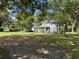 Charming two-story home with a well-maintained lawn and mature trees at 222 Spring Lake Hwy, Brooksville, FL 34602