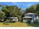 Charming two-story home with a covered porch and a lush green yard at 222 Spring Lake Hwy, Brooksville, FL 34602