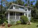 Charming two-story home with a covered porch and well-manicured landscaping at 222 Spring Lake Hwy, Brooksville, FL 34602