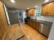 Well-lit kitchen features dark countertops, updated cabinets, stainless steel appliances, and wood-look flooring at 222 Spring Lake Hwy, Brooksville, FL 34602