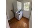 Laundry room with stacked washer and dryer and access to outside at 222 Spring Lake Hwy, Brooksville, FL 34602