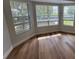Bright living room featuring large windows, light-colored walls, and beautiful hardwood floors at 222 Spring Lake Hwy, Brooksville, FL 34602