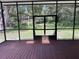 The spacious screened-in patio offers views of the property's greenery and lush landscape at 222 Spring Lake Hwy, Brooksville, FL 34602