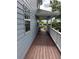 Cozy side porch with wood flooring and white railing, perfect for relaxing outdoors at 222 Spring Lake Hwy, Brooksville, FL 34602