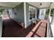 Wraparound porch with seating and views of the front and side yards at 222 Spring Lake Hwy, Brooksville, FL 34602