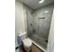 New bathroom shower with glass door and tiled floor at 222 Spring Lake Hwy, Brooksville, FL 34602