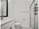 Modern bathroom with sleek glass shower, decorative niche, toilet, and vanity with a black framed mirror at 2511 N Grady Ave # 43, Tampa, FL 33607