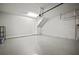 Large garage offering epoxy flooring, white painted walls, electric door, and access door to the home at 2511 N Grady Ave # 43, Tampa, FL 33607
