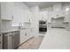 Modern kitchen with stainless steel appliances, quartz countertops, a tile backsplash, and ample cabinetry at 2511 N Grady Ave # 43, Tampa, FL 33607