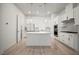 Modern kitchen featuring white cabinetry, stone countertops, stainless steel appliances, and an island at 2511 N Grady Ave # 43, Tampa, FL 33607