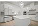 Modern, eat-in kitchen featuring sleek white cabinets and stainless steel appliances at 2511 N Grady Ave # 43, Tampa, FL 33607