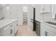 Modern kitchen features quartz countertops, ample cabinets, and an open walk-in pantry with shelving at 2511 N Grady Ave # 43, Tampa, FL 33607
